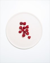 High Angle View of Raspberries on Round White Plate