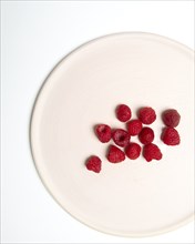 High Angle View of Raspberries on Cropped White Plate