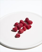 Raspberries on Cropped White Plate