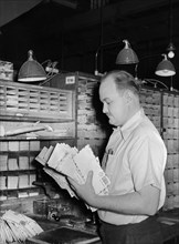 Worker sorting mail at Main Post Office, Washington, 1938