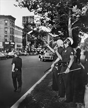 Police Officers standing on Street with guns drawn and pointing upwards after rioting due to fatal shooting of Teen James Powell by Police Officer Lt. Thomas Gilligan, Harlem, July 1964