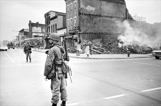 U.S. Soldier standing Guard near Ruins of Buildings destroyed by Riots following Dr. Martin Luther King Jr's, Assassination, 1968