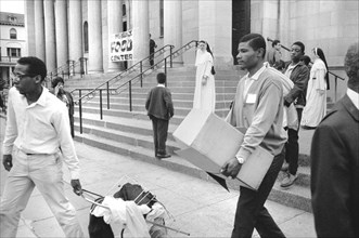 African American Men carrying Supplies from Food Distribution Center at Church after Riots following Dr. Martin Luther King Jr's, Assassination, 1968