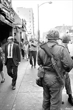 Members of National Guard patrolling streets as pedestrians walk by after riots following Dr. Martin Luther King Jr's, Assassination, April 8