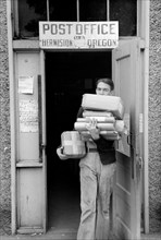 Man with Packages leaving Post Office, Hermiston, September 1941