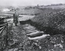Chaplain T.R. White standing before Mass Burial Site for Soldiers that died while at Red Cross Hospital no. 114, Fleury sur Aisne,