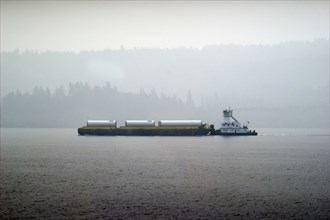 Barge in Columbia river, wildfire smoke obstructing distant view,