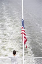 Rear View of Young Boy on Ferry with American Flag,,