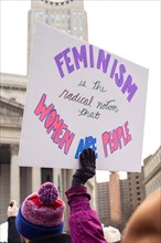 Woman holding Sign, "Feminism is the Radical Notion", USA