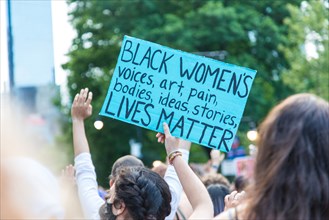 Woman Protester holding Sign, Black Women's Lives Matter,