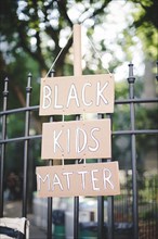 Black Kids Matter Sign Hanging on Metal Fence, New York City,
