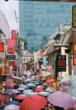 Umbrellas filling Narrow Street, Tokyo,