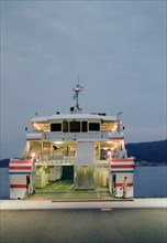 Ferry Worker in front of Boat at Sunset, Miyajima,