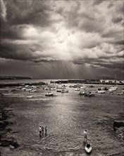 Light Ray through Dramatic Clouds over Harbor, Portrush,