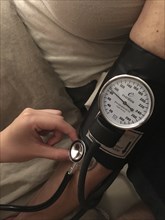 Nurse taking Patient's Blood Pressure,,