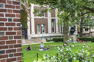 Three Students with Protective Masks sitting on lawn in front of Philosophy Hall, Columbia University,