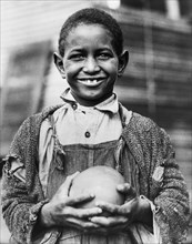 Young Boy with Grapefruit supplied by American Red Cross to Drought Victims, Mound Bayou