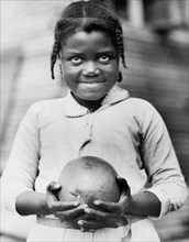 Young Girl with Grapefruit supplied by American Red Cross to Drought Victims, Mound Bayou