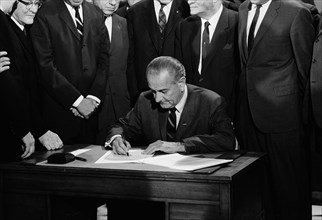 U.S. President Lyndon Johnson signing Civil Rights Bill while surrounded by Members of Congress, Washington