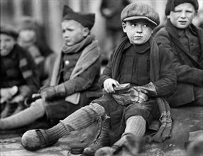 Young Orphan Boys shining their Leather Boots received from Junior Red Cross of America, Ypres