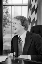 U.S. President Jimmy Carter working on T.V. speech in Oval Office, White House