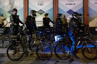 Heavily Geared NYPD Officers on Bicycles at Night, before Election