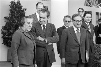 Israeli Prime Minister Golda Meir standing with U.S. President Richard Nixon and U.S. Secretary of State Henry Kissinger