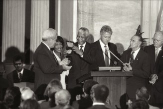 Nelson Mandela receiving Congressional Gold Medal from U.S. President Clinton