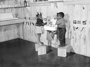 Agricultural workers' children washing up before a hot lunch in day nursery at Okeechobee migratory labor camp. Belle Glade