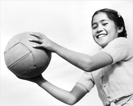 Young Japanese-American Girl with Volleyball
