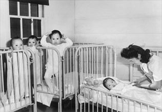 Nurse tending to Orphan Infants in Nursery