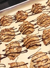 Coconut Macaroons with Chocolate Drizzle on Baking Sheet