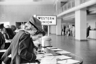 Two Western Union Employees filling out Paperwork