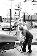 Man pumping Gasohol at Gas Station