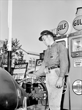 Gas Station attendant filling Gas Tank of Car
