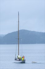 Rearview of Classic Wooden Yacht leaving Mooring