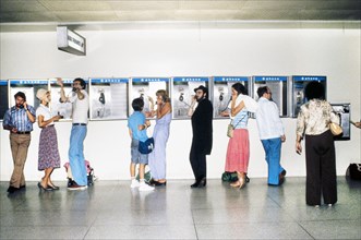Group of People using Pay Telephones