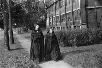 Two Nuns walking along Street