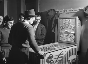 Group of Men playing Pinball Machine at Steelworkers' Serbian Club