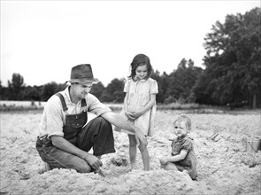 Tenant Farmer with two of his Children in Field ready for Tobacco Planting