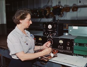 Woman working with the electric wiring at Douglas Aircraft Company