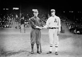 Johnny Evers (left) of National League champion