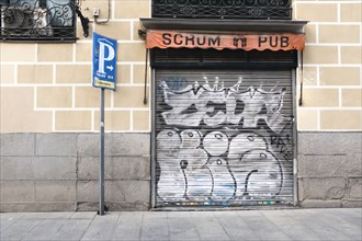 Scrum Pub storefront with graffiti on security door