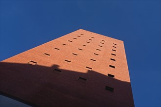 Low Angle View of Shadow on Red Brick Building against Blue Sky