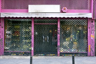 Pink Storefront with Closed Metal Security Doors