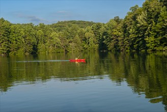 Boy in Red Kayak on Lake