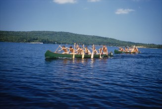 Camp Boys rowing Canoes