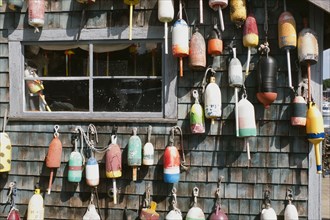 Lobster Trap Buoys hanging on side of Rustic Building