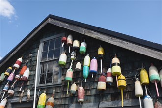 Lobster Trap Buoys hanging on side of Rustic Building