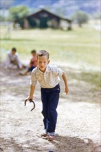 Young boy playing Horseshoes